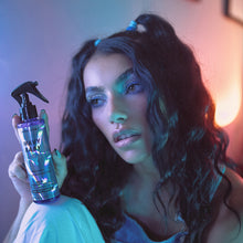 Load image into Gallery viewer, Woman holds a bottle of Wavy Baby