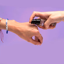 Load image into Gallery viewer, Woman dispenses Voodoo Oil on another person&#39;s hand
